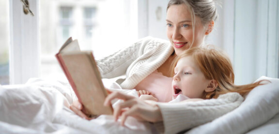 Mother reading to her daughter. Mother reading to her daughter.